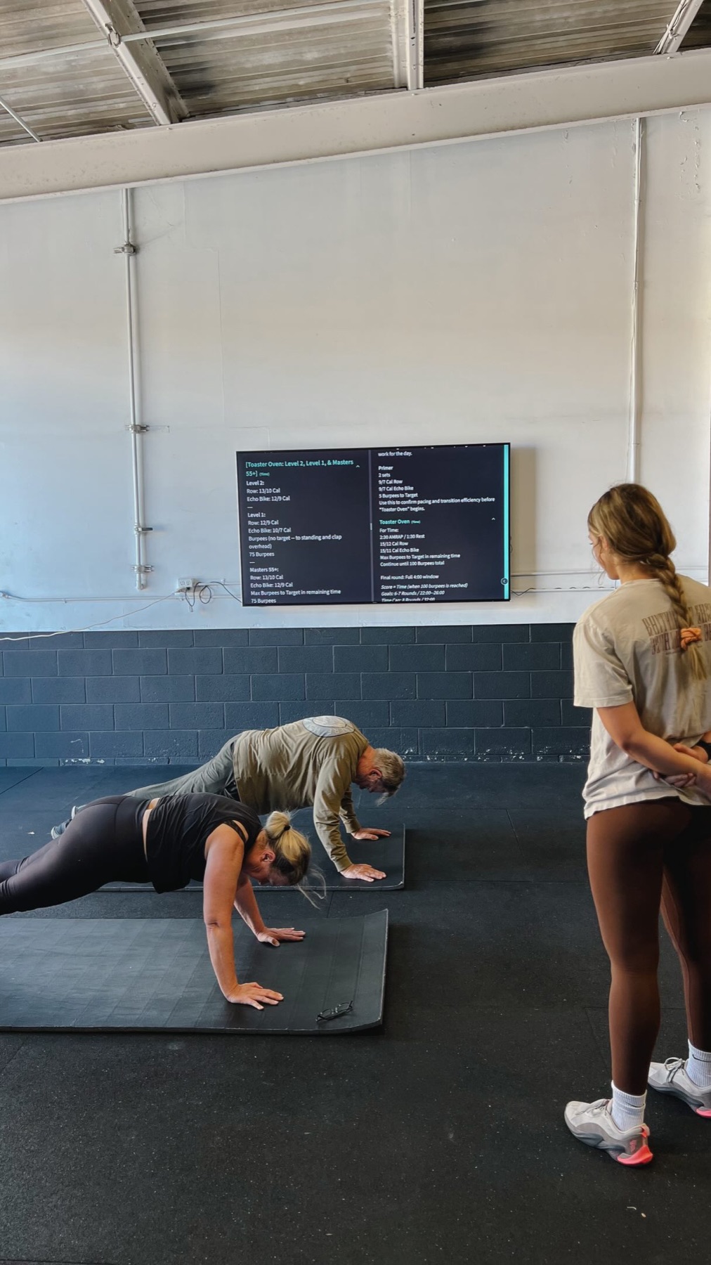A coach teaching a beginner the basics at O-SEA Fit in San Clemente